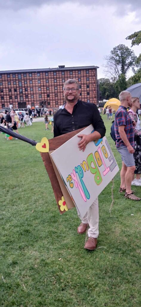 mężczyzna niosący kartony z napisami